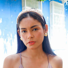 Load image into Gallery viewer, Model wearing a blush pink jeweled headband with pearl and crystal embellishments outdoors.