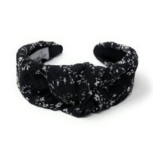 Load image into Gallery viewer, Chic black knotted hairband with subtle floral pattern and comfortable wide-band silhouette