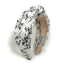 Load image into Gallery viewer, Vintage-inspired black and white floral knot headband displayed against a clean backdrop.