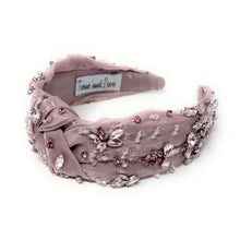 Load image into Gallery viewer, Elegant pink headband adorned with sparkling crystals and gemstones. The luxurious fabric is delicately ruched, creating a sophisticated and glamorous look.