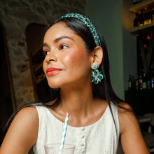 Load image into Gallery viewer, Floral design green earrings worn by a woman enjoying a cocktail
