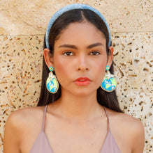 Load image into Gallery viewer, Chic accessory styling with planet-inspired statement earrings and a sparkly blue hairband.
