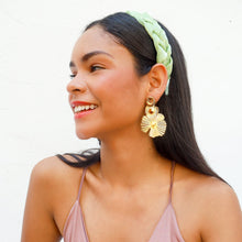 Load image into Gallery viewer, A fashion model showcasing a green braided headband and golden accessories.