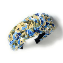 Load image into Gallery viewer, Elegant padded knot headband adorned with soft blue flowers and earthy green accents for a timeless feminine style.