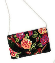 Load image into Gallery viewer, Artisan-made black clutch purse decorated with colorful blooming flowers, leafy accents, and detailed bead embroidery.