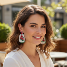 Load image into Gallery viewer, White beaded statement earrings with red flower embroidery and green details