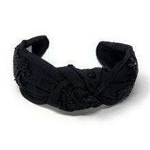 Load image into Gallery viewer, Black knotted headband with decorative elements on a white background