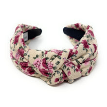 Load image into Gallery viewer, A stylish knotted floral headband with pink roses on a cream background.