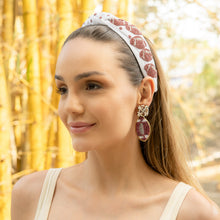 Load image into Gallery viewer, Woman wearing a decorative headband and football earrings with natural background