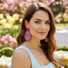 Load image into Gallery viewer, Woman wearing colorful earrings in a garden with Easter eggs and baskets