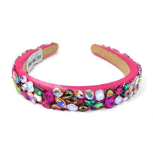 Load image into Gallery viewer, A vibrant pink headband adorned with multicolored gemstones, including blue, purple, and green. It exudes a playful, glamorous vibe.