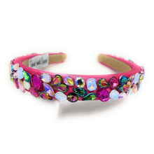 Load image into Gallery viewer, A vibrant pink headband adorned with multicolored gemstones, including blue, purple, and green. It exudes a playful, glamorous vibe.