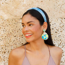Load image into Gallery viewer, Fashion portrait featuring colorful earth-themed drop earrings paired with a soft blue headband.