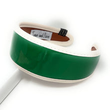 Load image into Gallery viewer, Glossy emerald green wide headband with a patent finish and ivory trim displayed on a white background.