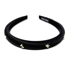 Load image into Gallery viewer, Elegant black satin headband adorned with small gold bow embellishments, displayed against a plain white background, conveying a stylish and chic tone.