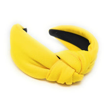 Load image into Gallery viewer, Bright yellow padded headband featuring a stylish front knot design and a comfortable structured band.