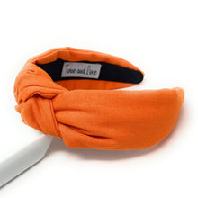 Load image into Gallery viewer, Elegant orange linen-look headband with a top knot design, perfect for everyday wear and seasonal styling.