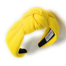 Load image into Gallery viewer, Statement yellow fabric headband with a twisted knot detail and soft padded silhouette.