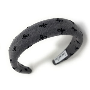 Gray headband with black bow pattern on a white background