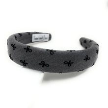 Load image into Gallery viewer, Gray headband with black bow pattern on a white background