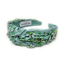 Load image into Gallery viewer, Elegant green headband adorned with sparkling crystals and gemstones. The luxurious fabric is delicately ruched, creating a sophisticated and glamorous look.