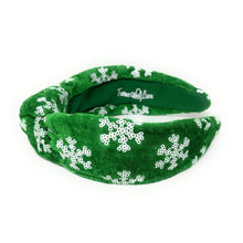 Load image into Gallery viewer, Green velvet headband adorned with white snowflake patterns. The texture is soft and plush, giving a festive, cheerful vibe against a plain white background.