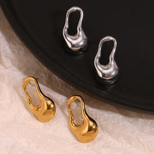 Load image into Gallery viewer, Gold and silver earrings on a textured surface with a black background