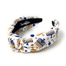 Load image into Gallery viewer, A fabric twisted headband featuring a white background with a blue and gold menorah and star pattern, shown on a clean white background.