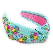 Load image into Gallery viewer, Close-up of pastel rainbow beaded earrings featuring daisy accents and inspirational “Be Kind” detail with matching floral headband.