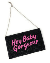 Load image into Gallery viewer, Black handcrafted beaded purse with bold pink text reading “Hey Baby Gorgeous,” carried by a woman in a white top and denim jeans.