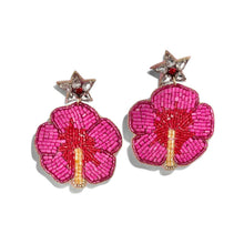 Load image into Gallery viewer, A pair of beaded flower drop earrings with vibrant pink petals, red centers, gold stems, and silver star-shaped posts with small red gem accents, shown on a plain white background.