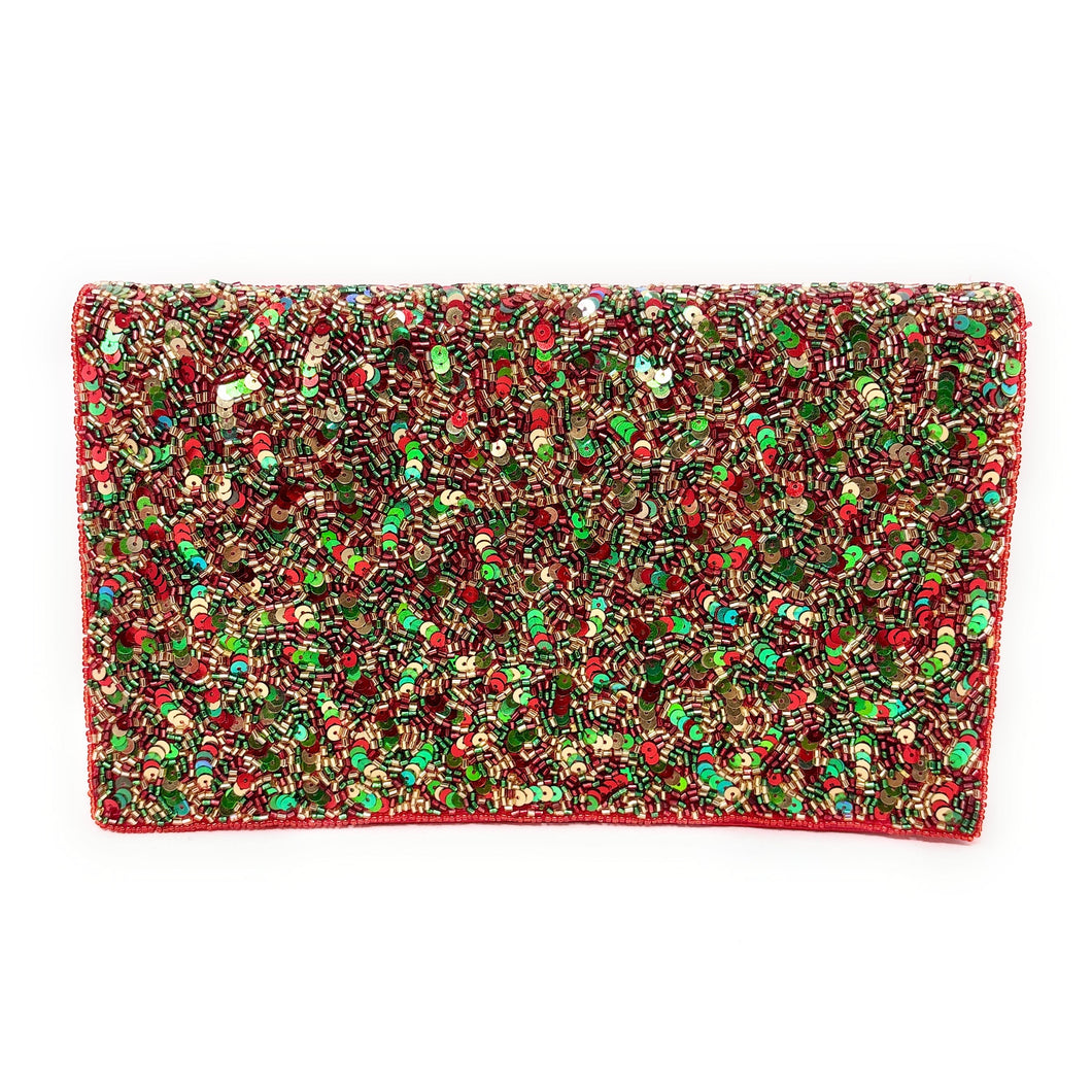 A rectangular clutch adorned with a dense pattern of shimmering red, green, and gold sequins, creating a festive and vibrant appearance.