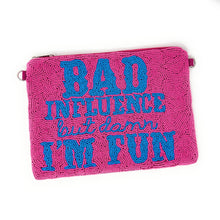 Load image into Gallery viewer, A pink clutch bag with blue beaded text reading &quot;Bad influence but damn I&#39;m fun.&quot; The words convey a playful and bold tone.