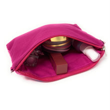 Load image into Gallery viewer, Pink makeup pouch with cosmetic items on a white background