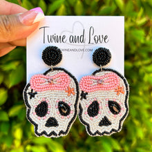 Load image into Gallery viewer, Halloween beaded Earrings, beaded halloween Earrings, halloween Earrings, Halloween Bead Earrings, earrings for halloween, pink bow skull earrings, spooky beaded earrings, skull earrings, Unique earrings, statement earrings, Halloween jewelry, Pink bow earrings, candy corn, spooky earrings, costume jewelry, Holiday earrings, custom earrings, custom designs, cat earrings, dangling earrings, lightweight earrings, autumn accessories, halloween vibes, spooky vibes, trick or treat accessories, handmade gifts