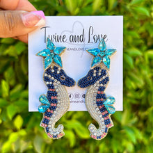 Load image into Gallery viewer, custom beaded Earrings, seahorse jeweled Earrings, blue seahorse Beaded Earrings, summer jeweled earrings, handmade earrings, custom earrings, beach accessories, beach accessories, seahorse embellished earrings, custom earrings, best friend gifts, birthday gifts, bohemian earrings, luxurious handmade accessories, beach jewelry, Fancy earrings, boho earrings, beaded earrings, beach jeweled earrings, statement earrings, best selling items, beach accessories, handmade gifts, custom gifts, seahorse earrings 