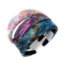 Load image into Gallery viewer, Multicolored fabric-covered ring with a silver band on a white background