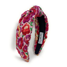 Load image into Gallery viewer, Floral patterned headband with a brand label on a white background