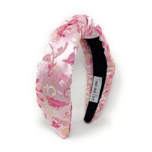 Load image into Gallery viewer, Pink satin headband with gold floral embroidery and a twisted knot design. The headband is set against a white background, conveying elegance.