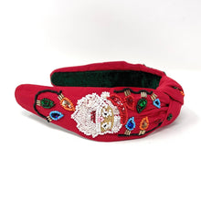 Load image into Gallery viewer, Red headband adorned with colorful beaded designs. The festive patterns create a cheerful, holiday-inspired look against a white background.