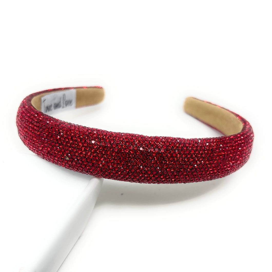 Red rhinestone headband on a white background