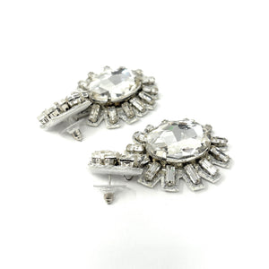 Elegant drop earrings featuring large, oval gemstones surrounded by smaller, radiant crystals on a white background, exuding a glamorous tone.