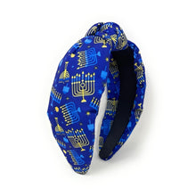 Load image into Gallery viewer, A fabric headband featuring a blue and gold Hanukkah pattern with menorahs, stars, and dreidels, displayed on a clean white background.