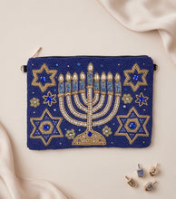 Load image into Gallery viewer, Blue and gold menorah pouch styled with elegant Hanukkah-inspired accessories.
