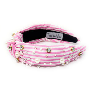 Pink and white striped headband with pearls and crystals on a white background