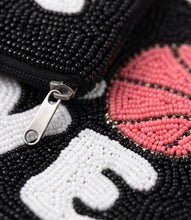 Load image into Gallery viewer, Close-up of a handmade Love Basketball zipper pouch with intricate white and red beadwork