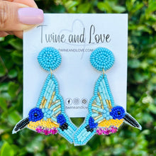 Load image into Gallery viewer, custom beaded Earrings, jeweled Earrings, hummingbird Beaded Earrings, blue earrings, blue jeweled earrings, handmade earrings, custom earrings, resort accessories, fancy accessories, hummingbird earrings, custom earrings, best friend gifts, birthday gifts, bohemian earrings, luxurious handmade accessories, party earrings, Fancy earrings, boho earrings, beaded earrings, white embellished earrings, Fancy jeweled earrings, bird earrings, statement earrings, best selling items