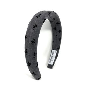 Gray headband with black bow pattern on a white background