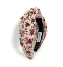 Load image into Gallery viewer, A stylish knotted floral headband with pink roses on a cream background.