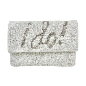 Elegant white clutch with sparkling beads, featuring the words "I Do!" in bold, silver lettering. It has a silver chain, conveying a bridal theme.
